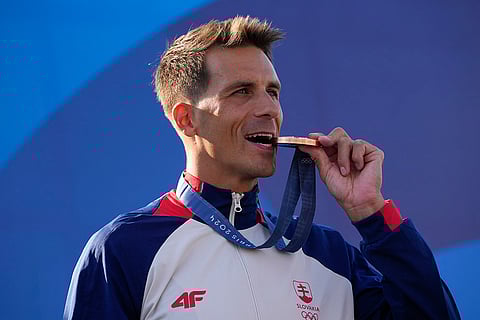 Men's slalom C-1 medal ceremony: Bronze medalist Matej Benus of Slovakia